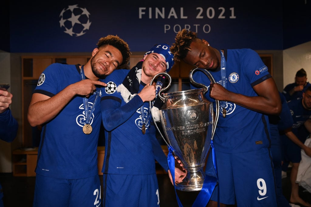 Reece James, Mason Mount and Tammy Abraham of Chelsea celebrate inside the dressing room with the Champions League Trophy