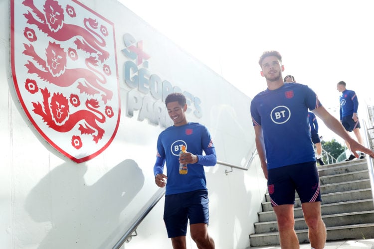 BURTON-UPON-TRENT, ENGLAND - JUNE 08: Jude Bellingham and Declan Rice of England look on during an England Training Camp at St Georges Park on June...