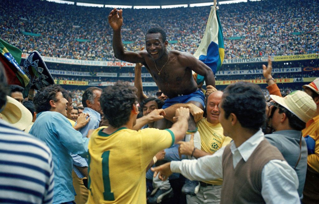 Pele lifted up after winning the World Cup with Brazil.