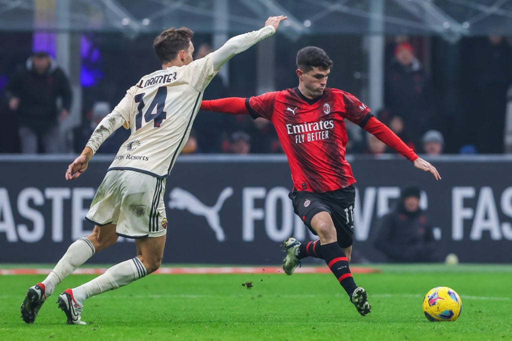 Christian Pulisic of AC Milan (R) and Diego LLorente of AS