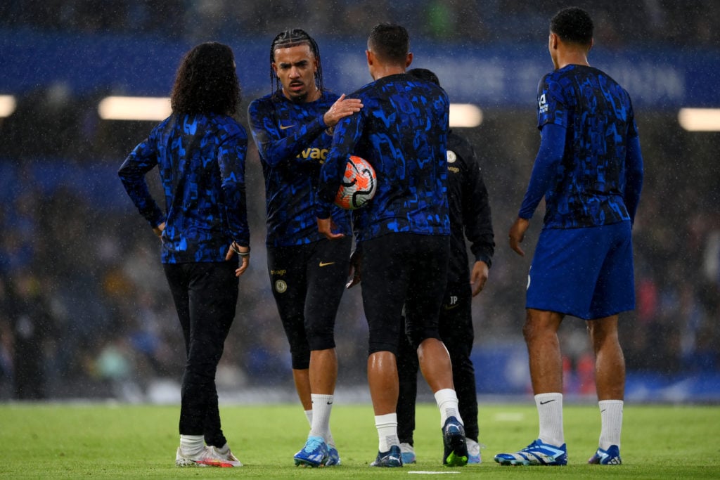 Malo Gusto of Chelsea interacts with Thiago Silva as the team warms up prior to the Premier League match between Chelsea FC and Arsenal FC at Stamf...