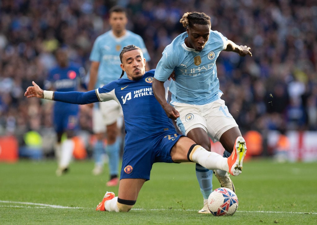 Jeremy Doku of Manchester City (right) is challenged by Malo Gusto of Chelsea during the Emirates FA Cup Semi Final match between Manchester City a...