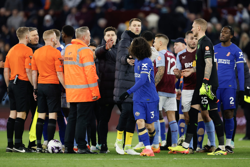 Mauricio Pochettino the head coach / manager of Chelsea stops his players from confronting referee Craig Pawson at full time during the Premier Lea...