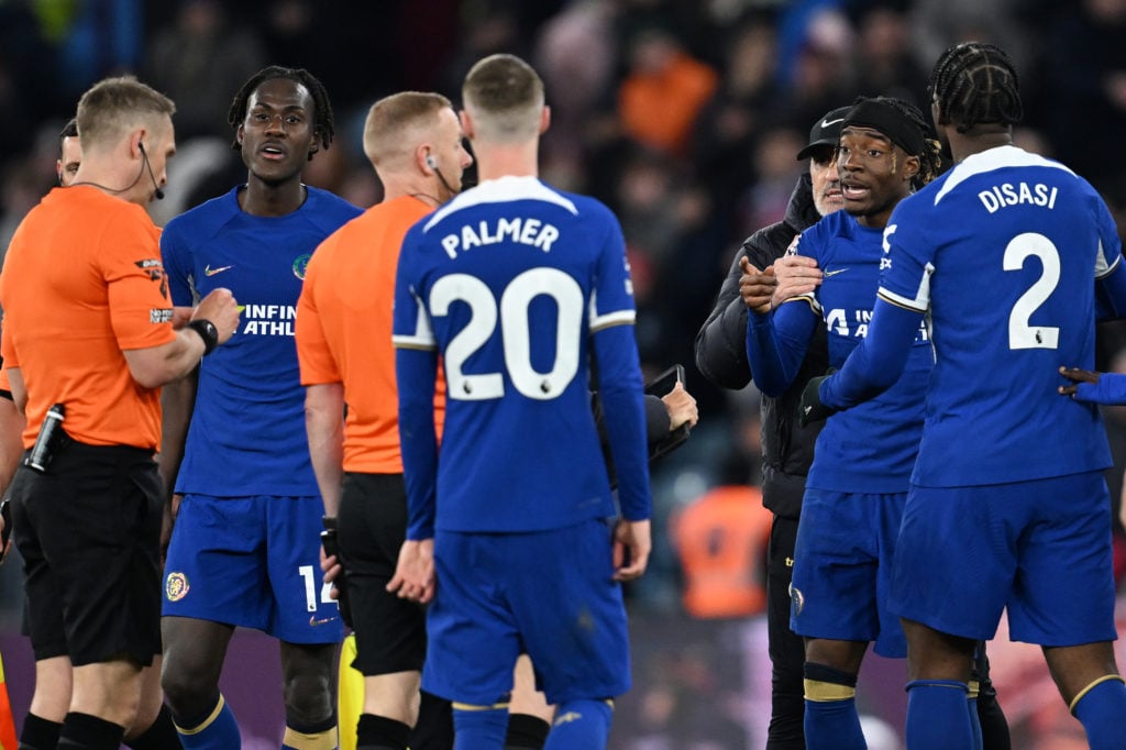 Referee Craig Pawson is confronted by Noni Madueke of Chelsea after the Premier League match between Aston Villa and Chelsea FC at Villa Park on Ap...