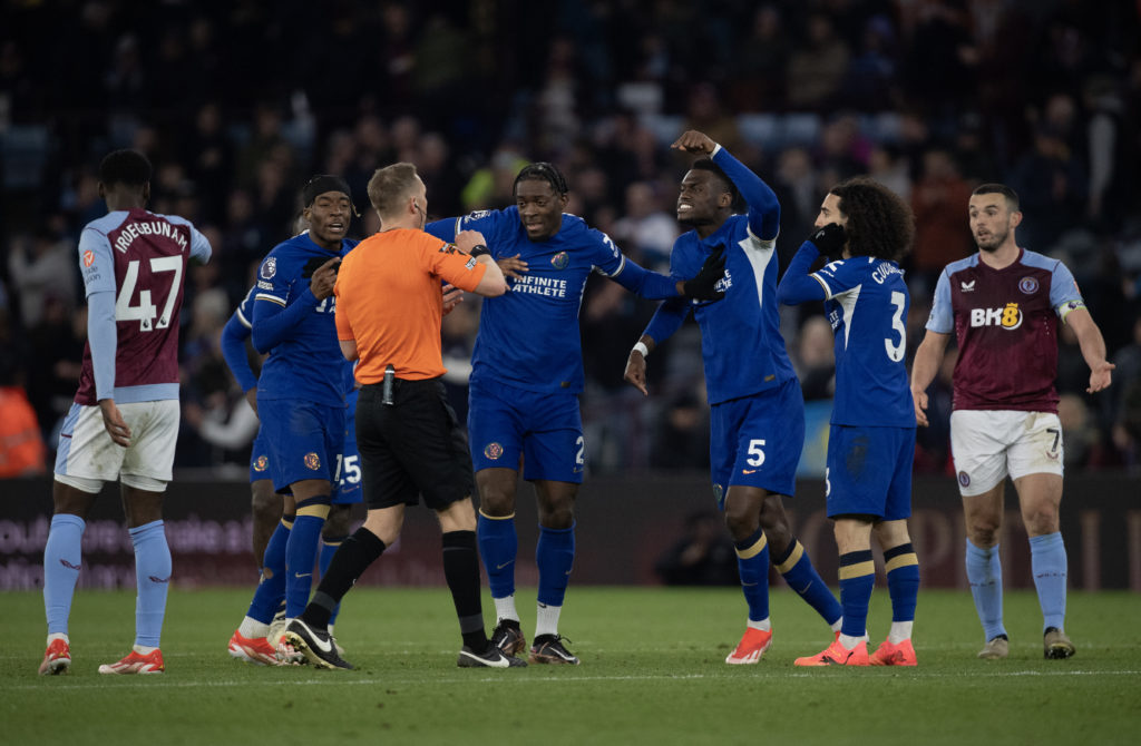 Noni Madueke, Axel Disasi and Benoit Badiashile of Chelsea argue with Match Referee Craig Pawson at the final whistle of the Premier League match b...
