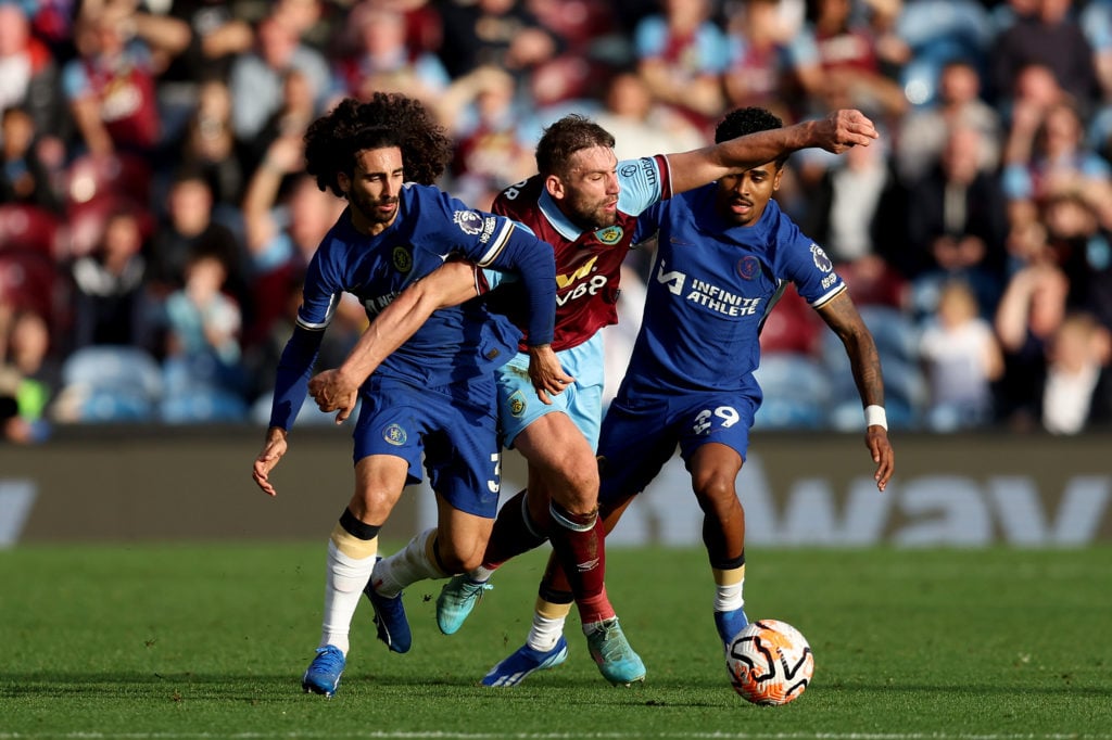 Charlie Taylor of Burnley is challenged by Marc Cucurella and Ian Maatsen of Chelsea during the Premier League match between Burnley FC and Chelsea...
