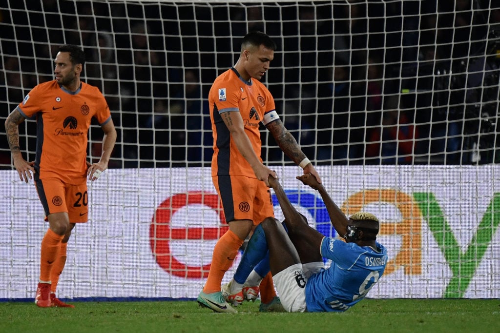 Inter Milan's Argentine forward #10 Lautaro Martinez helps Napoli's Nigerian forward #09 Victor Osimhen to get up during the Italian Serie A footba...