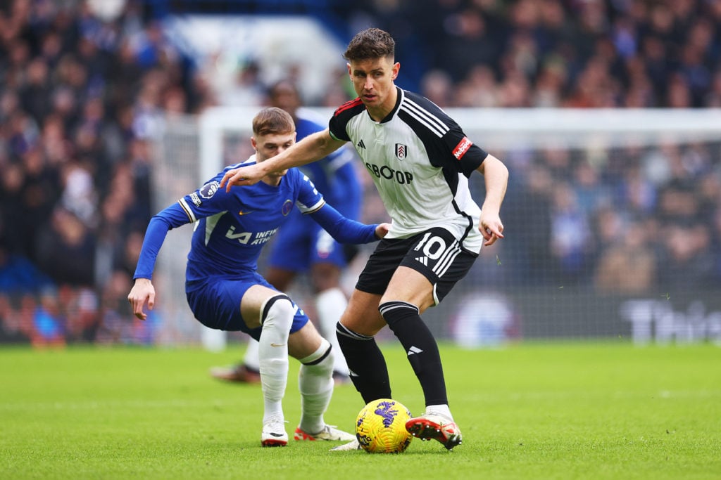 Tom Cairney of Fulham runs ahead of Cole Palmer of Chelsea during the Premier League match between Chelsea FC and Fulham FC at Stamford Bridge on J...