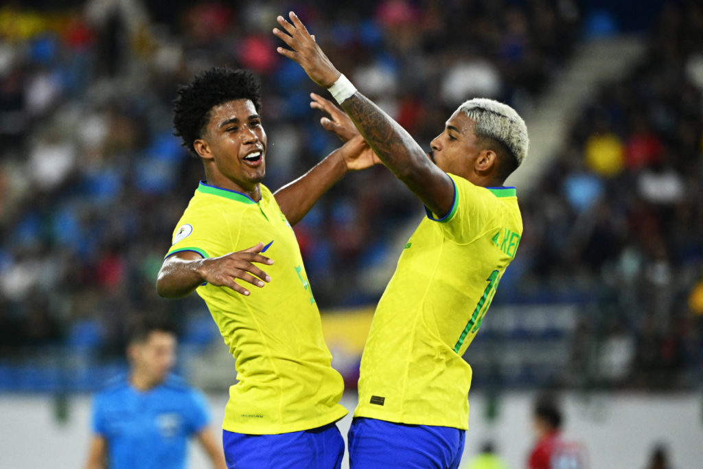 Brazil's John Kennedy (R) celebrates with Andrey Santos (L) after scoring during the Venezuela 2024 CONMEBOL Pre-Olympic Tournament Group A footbal...