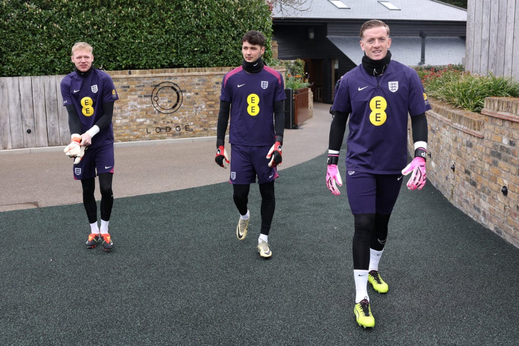 Aaron Ramsdale, James Trafford and Jordan Pickford of England walk to a training session at Tottenham Hotspur Training Centre on March 25, 2024 in ...