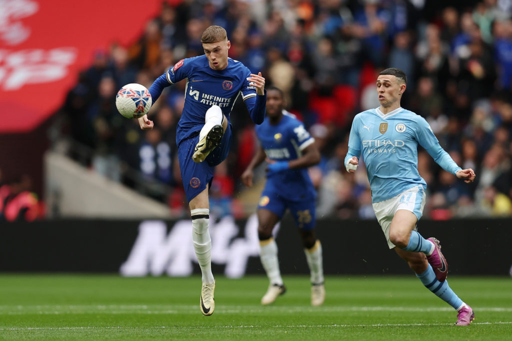 Cole Palmer of Chelsea passes the ball whilst under pressure from Phil Foden of Manchester City during the Emirates FA Cup Semi Final match between...