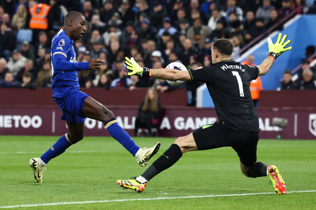 Chelsea's Senegalese striker #15 Nicolas Jackson (L) scores a goal past Aston Villa's Argentinian goalkeeper #01 Emiliano Martinez (R) that will be...