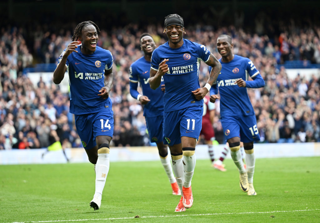 Noni Madueke of Chelsea celebrates scoring his team's third goal with teammate Trevoh Chalobah during the Premier League match between Chelsea FC a...
