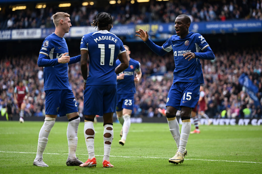 Nicolas Jackson of Chelsea celebrates scoring his team's fourth goal with teammates Cole Palmer and Noni Madueke during the Premier League match be...