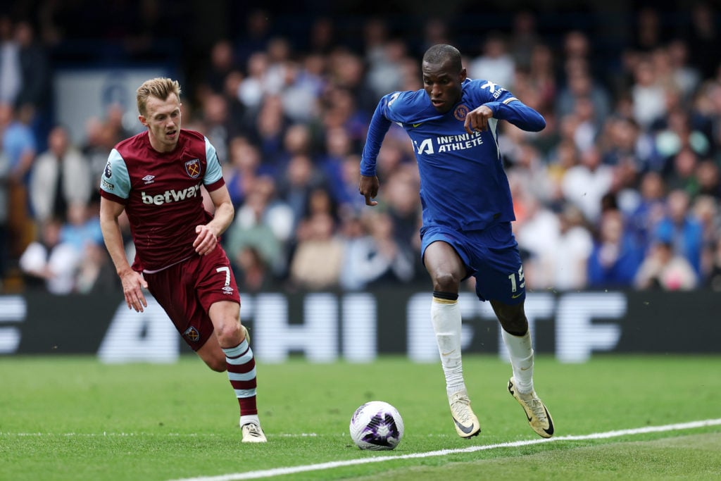 Nicolas Jackson of Chelsea runs with the ball whilst under pressure from James Ward-Prowse of West Ham United during the Premier League match betwe...