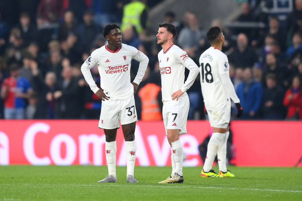 Kobbie Mainoo and Mason Mount of Manchester United look dejected after their side concedes the first goal scored by Michael Olise of Crystal Palace...