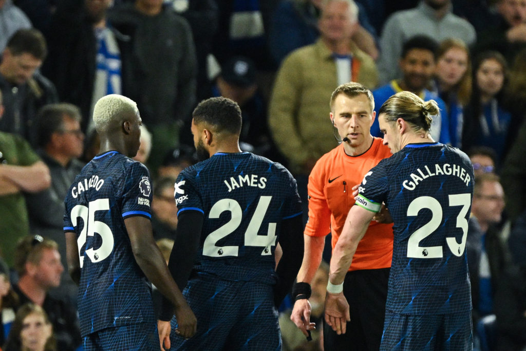 Referee (2nd R) speaks to Chelsea's English defender #24 Reece James (C) after giving him a red card during the English Premier League football mat...