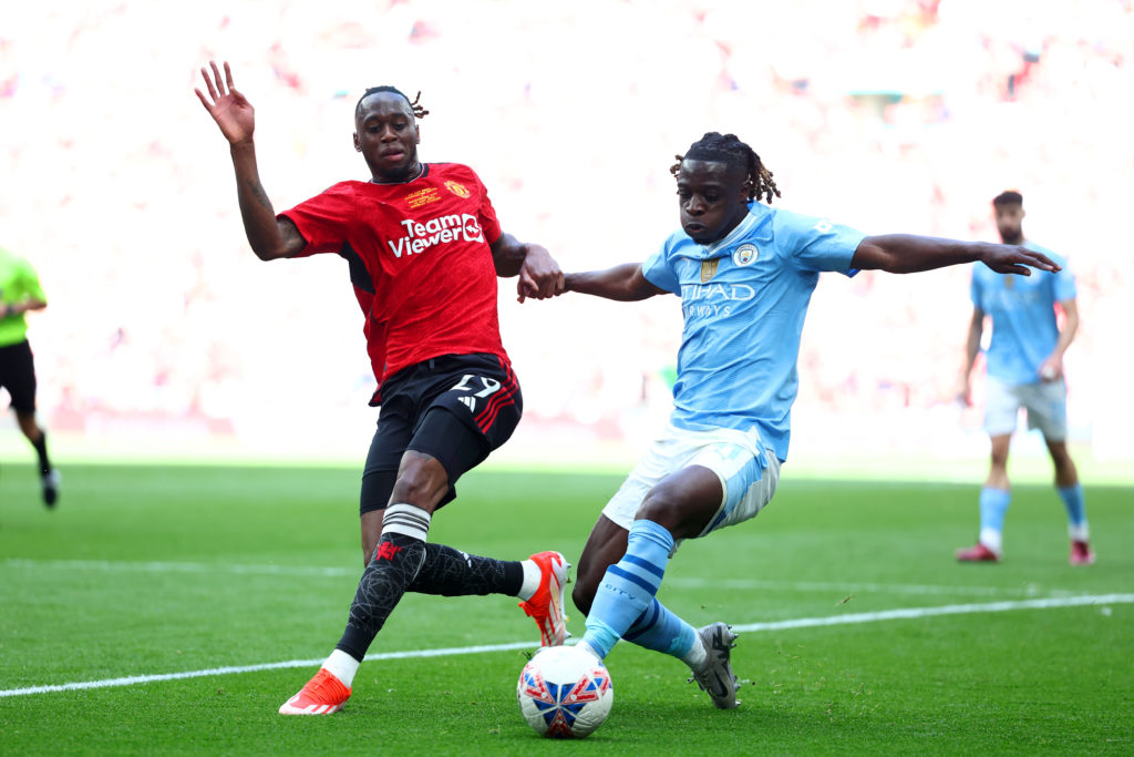 Jeremy Doku of Manchester City in action with Aaron Wan-Bissaka of Manchester United during the Emirates FA Cup Final match between Manchester City...