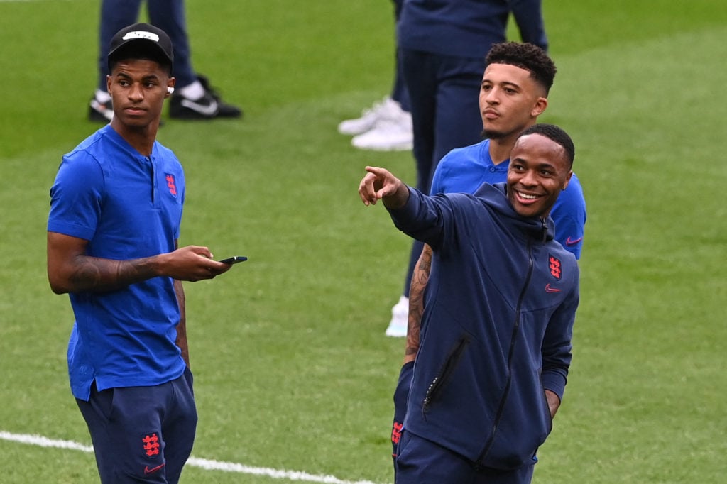 (L to R) England's forward Marcus Rashford, England's forward Jadon Sancho and England's forward Raheem Sterling inspect the pitch ahead of the UEF...