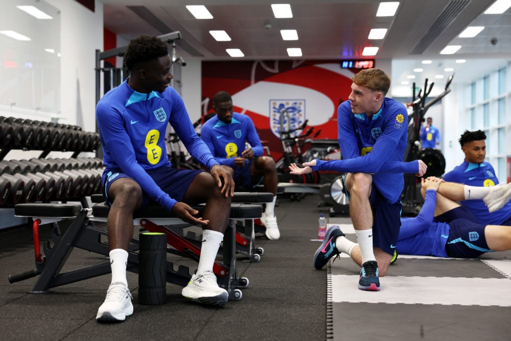 Bukayo Saka and Cole Palmer of England speak during an England Gym Session at St George's Park on November 14, 2023 in Burton upon Trent, England.