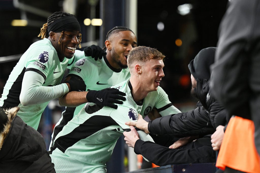 Cole Palmer of Chelsea celebrates Noni Madueke and Christopher Nkunku of Chelsea after scoring their team's third goal during the Premier League ma...