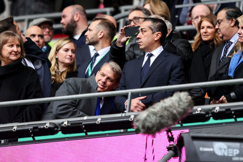 Chelsea co-owners Todd Boehly and Behdad Eghbali, with Boehly ducking down to allow a spectator behind him to take a picture on their phone, before...