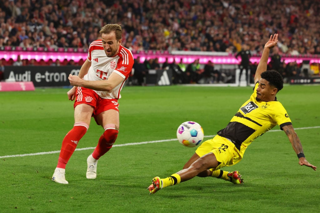 Harry Kane of Bayern Munich is challenged by Ian Maatsen of Borussia Dortmund during the Bundesliga match between FC Bayern München and Borussia Do...