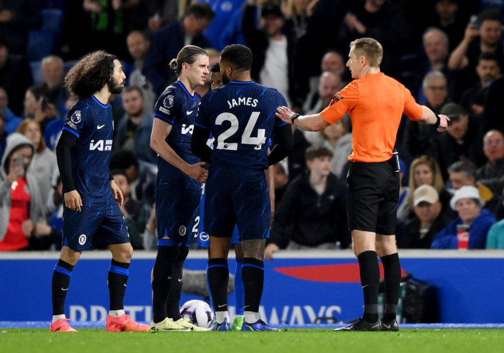 Referee Michael Salisbury speaks with Reece James and Conor Gallagher of Chelsea after showing Reece James a red card after he is adjudged to have ...