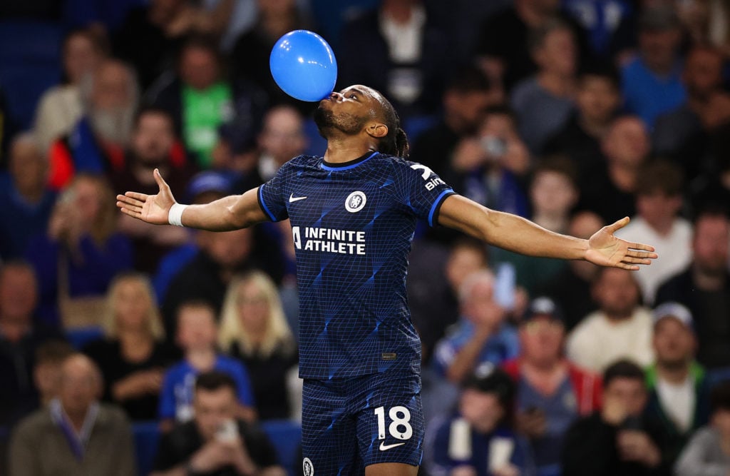 Christopher Nkunku of Chelsea celebrates scoring his team's second goal with a balloon during the Premier League match between Brighton & Hove ...