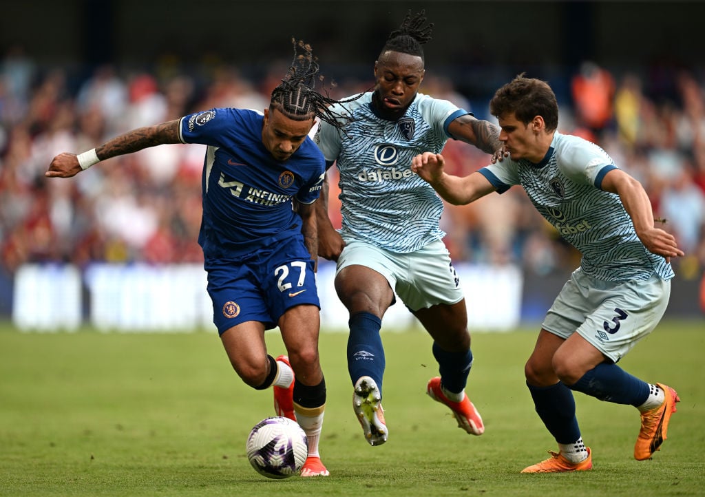 Malo Gusto of Chelsea runs with the ball whilst under pressure from Antoine Semenyo and Milos Kerkez of AFC Bournemouth during the Premier League m...