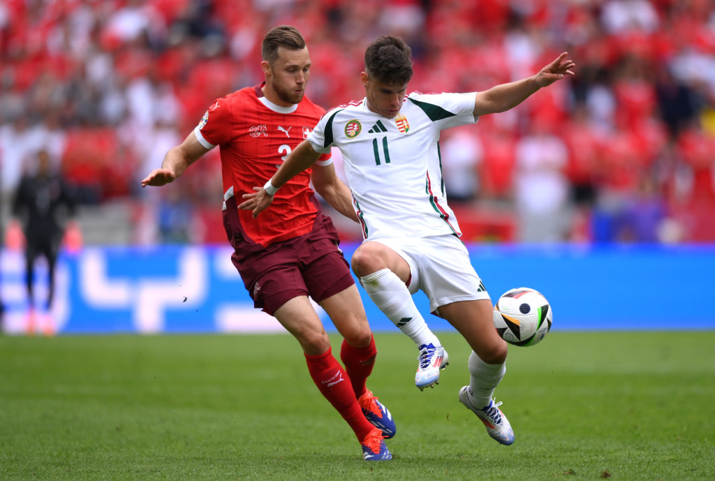 Milos Kerkez of Hungary holds off Silvan Widmer of Switzerland  during the UEFA EURO 2024 group stage match between Hungary and Switzerland at Colo...