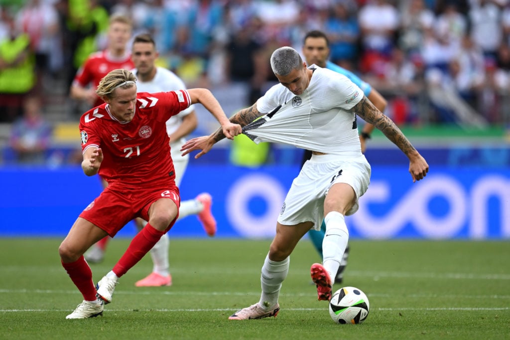 Morten Hjulmand of Denmark pulls the shirt of Benjamin Sesko of Slovenia during the UEFA EURO 2024 group stage match between Slovenia and Denmark a...