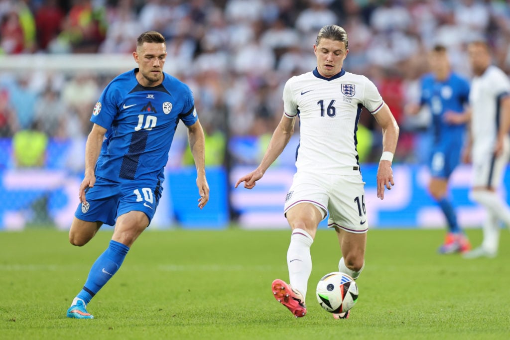 Conor Gallagher of England in action with Tim Elsnik of Slovenia during the UEFA EURO 2024 group stage match between England and Slovenia at Cologn...