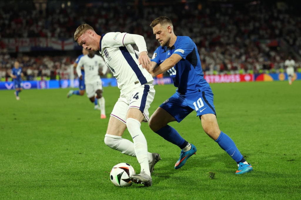 Cole Palmer of England controls the ball whilst under pressure from Timi Max Elsnik of Slovenia during the UEFA EURO 2024 group stage match between...