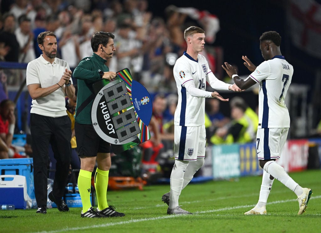 Substitute Cole Palmer comes on for Bukayo Saka of England as Coach Gareth Southgate applauds during the UEFA EURO 2024 group stage match between E...