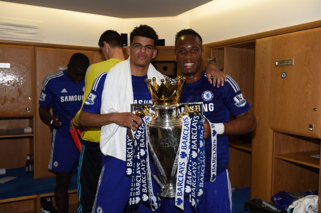 Chelsea's Dominic Solanke and Didier Drogba (right) celebrate with the Premier League Trophy in the dressing room after the match