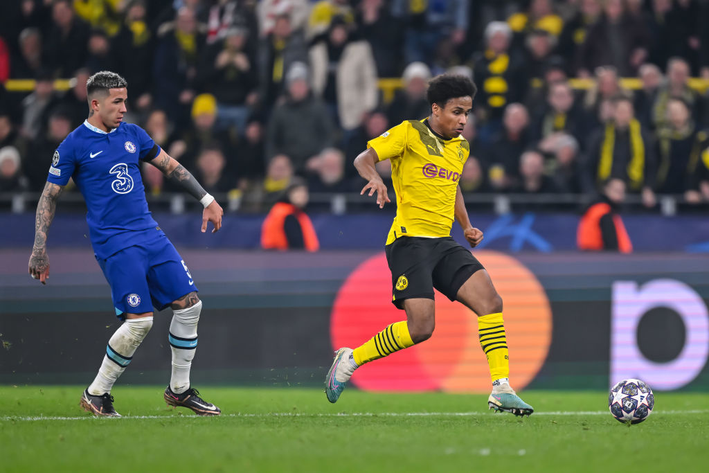 Enzo Fernandez of Chelsea FC and Karim Adeyemi of Borussia Dortmund battle for the ball during the UEFA Champions League round of 16 leg one match ...