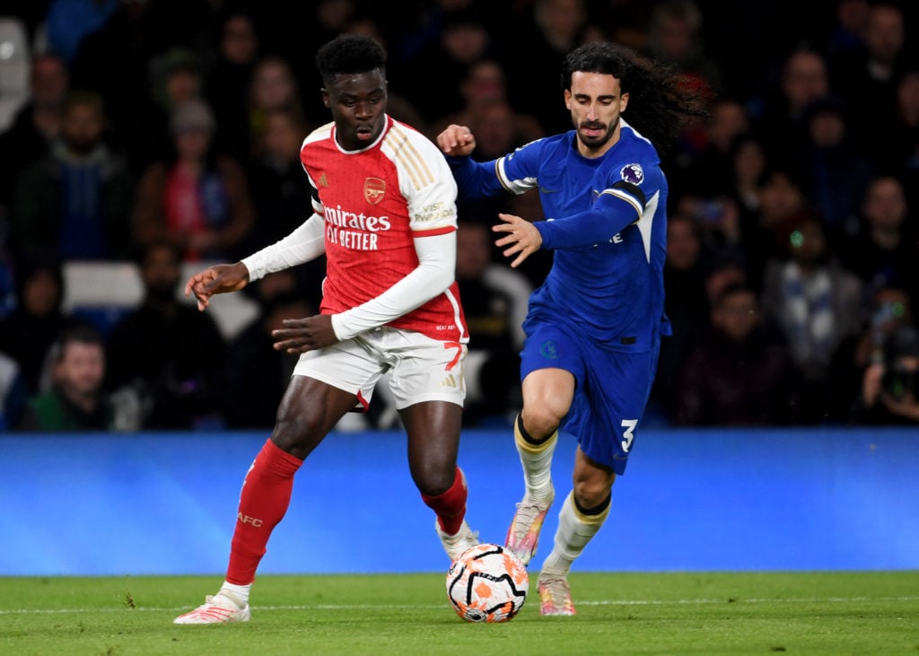 Bukayo Saka of Arsenal is challenged by Marc Cucurella of Chelsea during the Premier League match between Chelsea FC and Arsenal FC at Stamford Bri...
