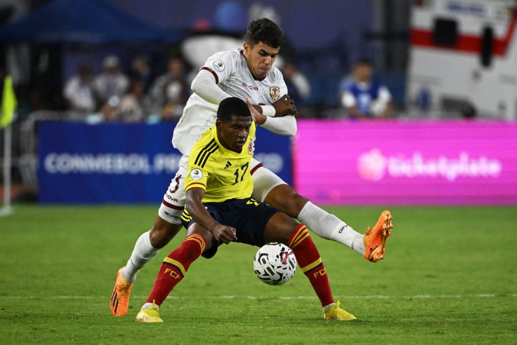 Colombia's Oscar Perea (Front) and Venezuela's Rafael Uzcategui (Back) fight for the ball during the Venezuela 2024 CONMEBOL Pre-Olympic Tournament...