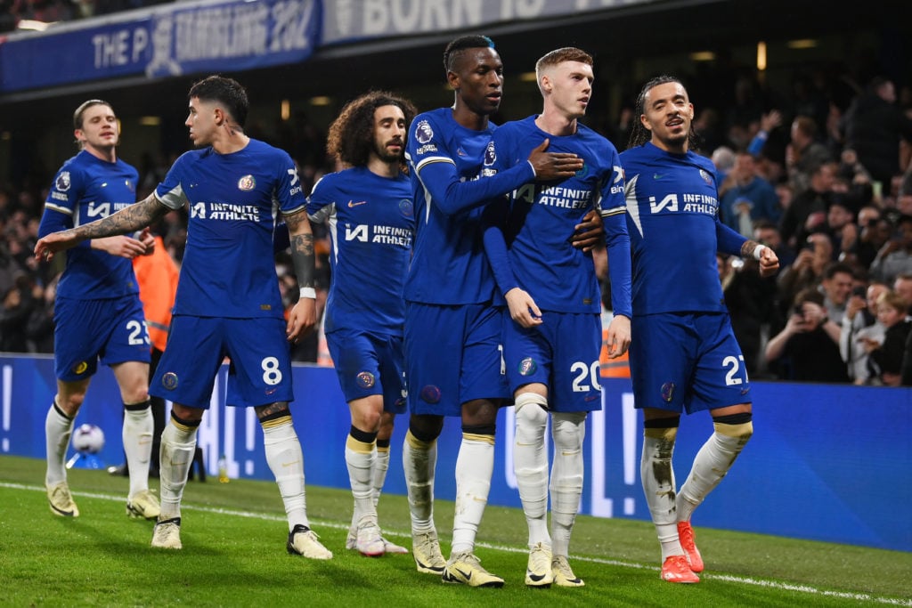 Cole Palmer of Chelsea celebrates scoring his team's first goal from a penalty kick with teammates Nicolas Jackson and Malo Gusto during the Premie...