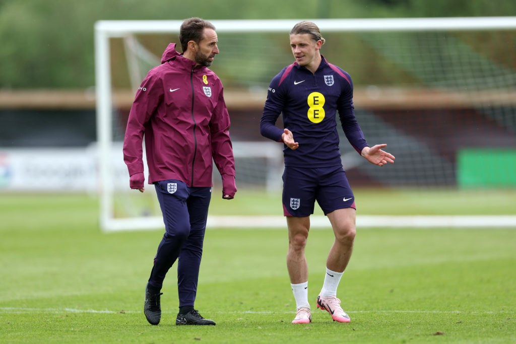 Gareth Southgate, Manager of England men's senior team, talks to Conor Gallagher of England during a training session at Rockliffe Park on May 30, ...