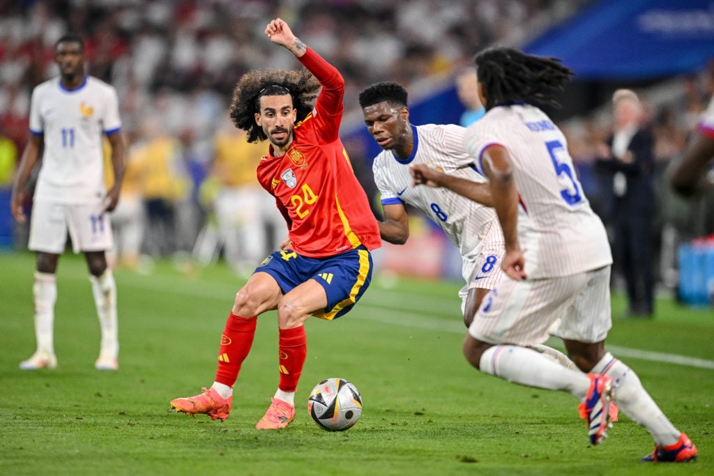 Marc Cucurella of Spain, Aurélien Tchouameni of France and Jules Koundé of France battle for the ball during the UEFA EURO 2024 semi-final match be...