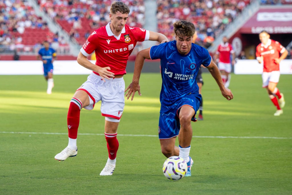 Chelsea forward Marc Guiu (R) fights for the ball with Wrexham defender Lewis Brunt (L) during a pre-season friendly football match between Chelsea...