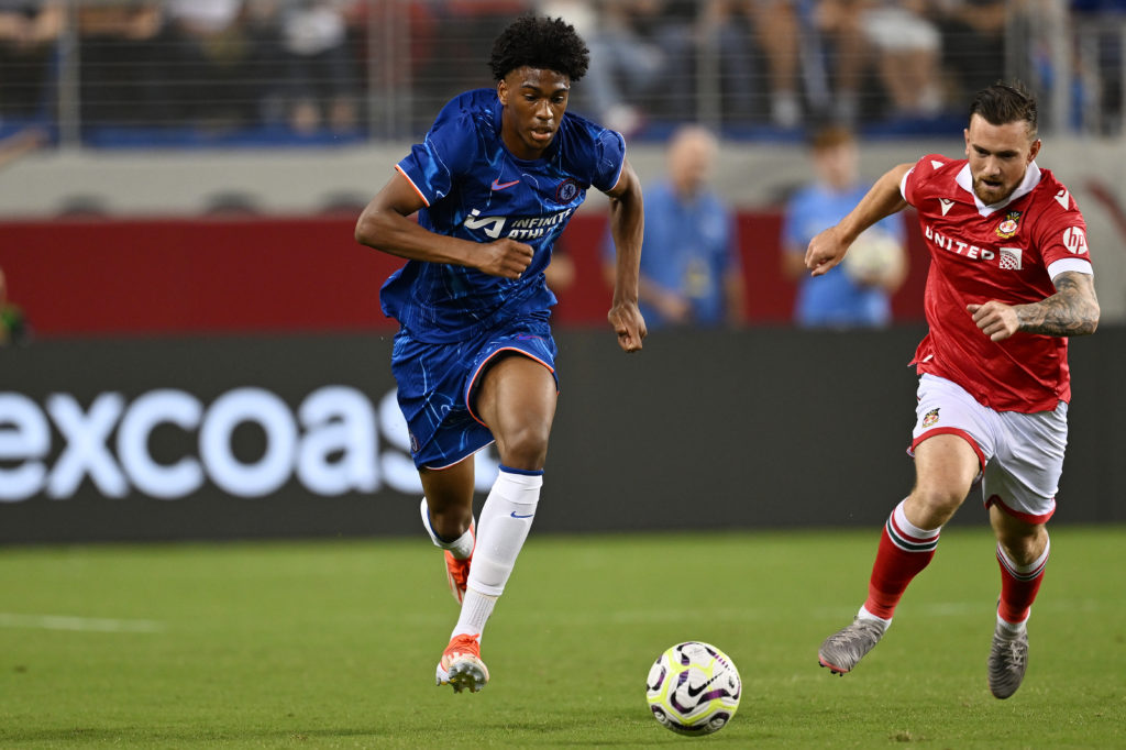 Jack Marriott of Wrexham chases as Josh Acheampong of Chelsea moves the ball during the Pre-Season Friendly match between Chelsea FC and Wrexham at...