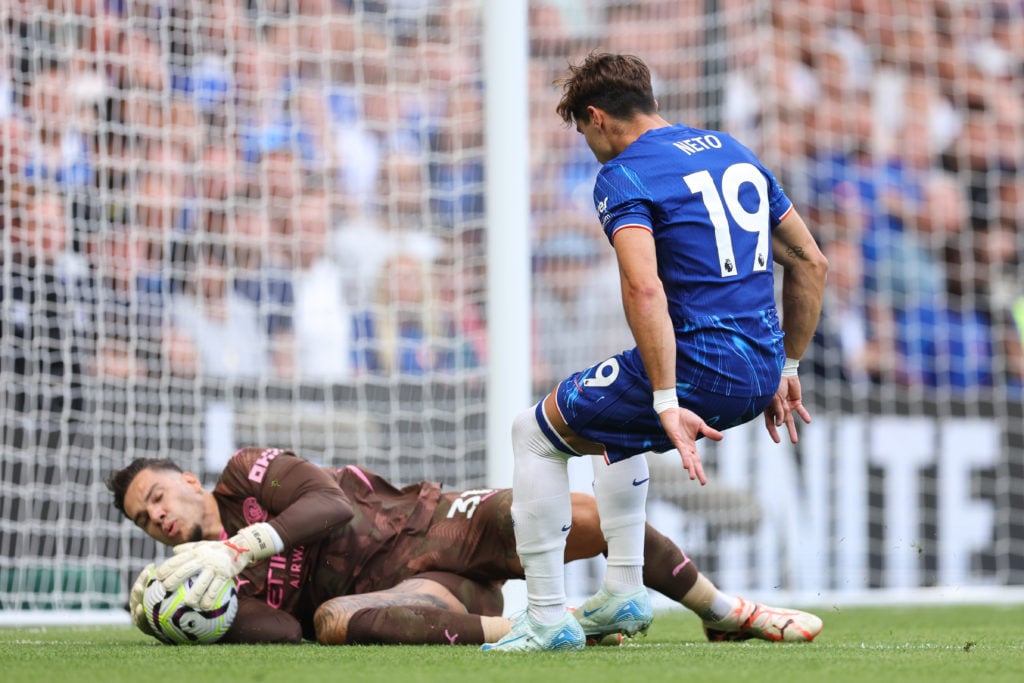 Ederson of Manchester City saves from Pedro Neto of Chelsea during the Premier League match between Chelsea FC and Manchester City FC at Stamford B...