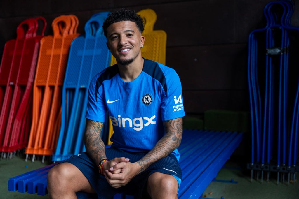 Jadon Sancho poses for pictures as he signs for Chelsea.