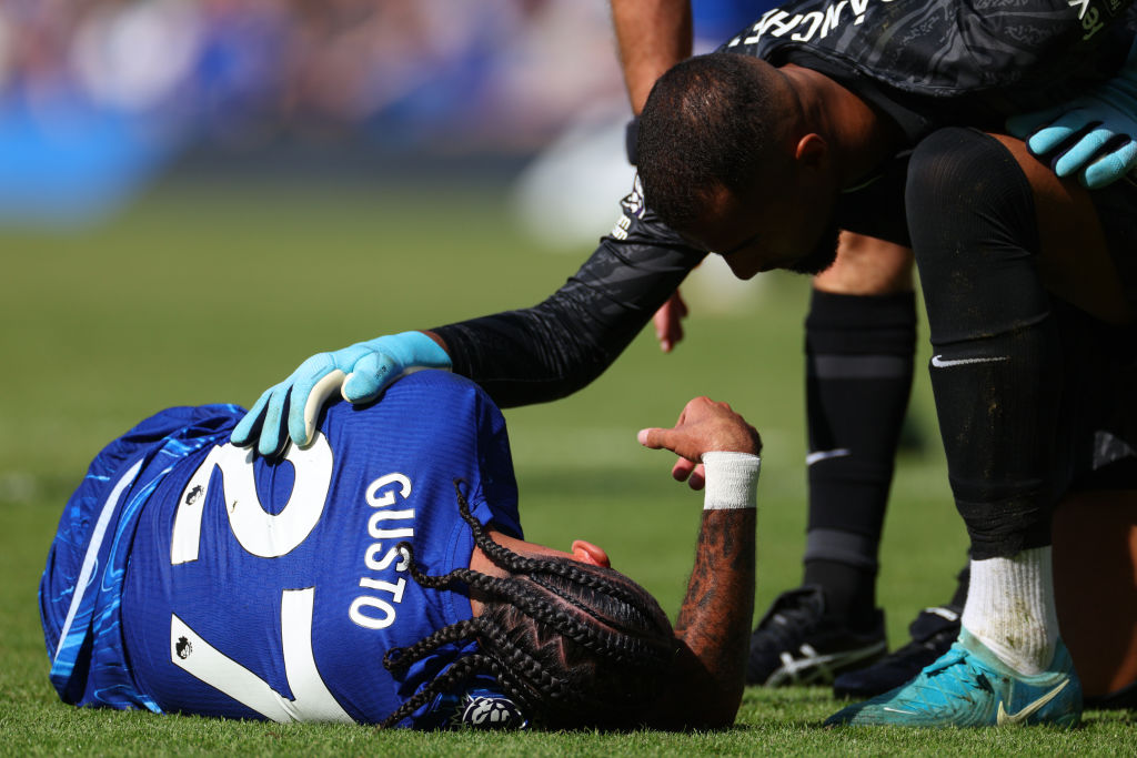 Malo Gusto of Chelsea lays injured during the Premier League match between Chelsea FC and Crystal Palace FC at Stamford Bridge on September 01, 202...