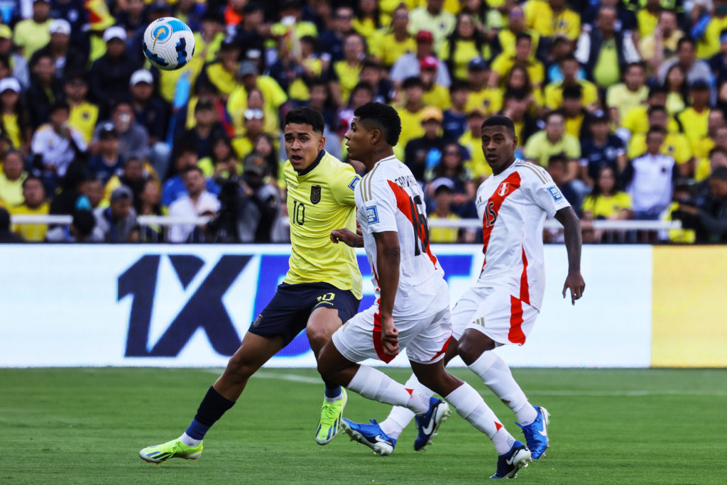 Kendry Paez of Ecuador battles for the ball with Wilder Cartagena of Peru during the South American FIFA World Cup 2026 Qualifier match between Ecu...