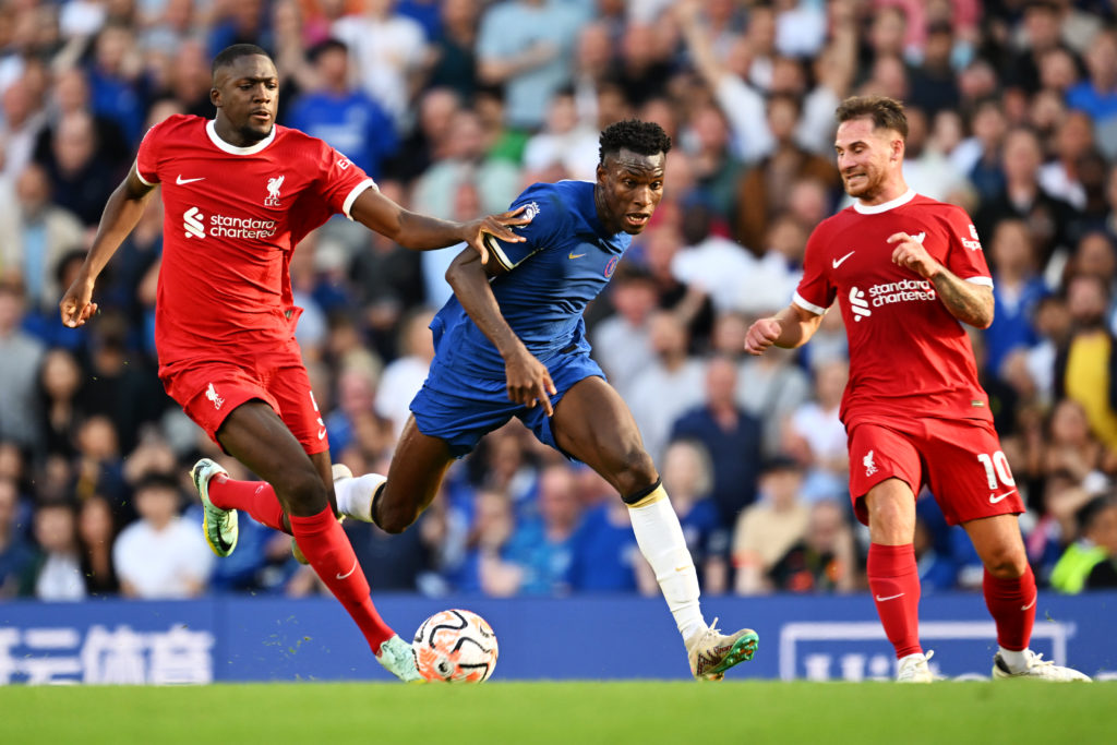 Nicolas Jackson of Chelsea runs with the ball whilst under pressure from Ibrahima Konate of Liverpool during the Premier League match between Chels...