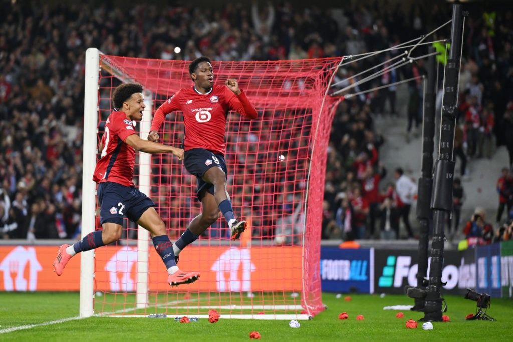 Jonathan David of LOSC Lille celebrates scoring his team's first goal from the penalty spot with Tiago Santos during the UEFA Champions League 2024...